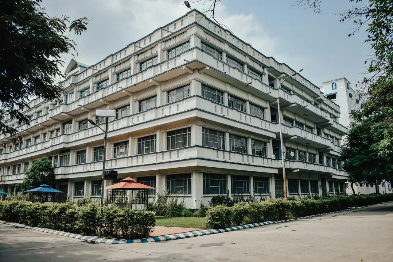 A multi-storey institutional building with deep horizontal balconies and wide flat roof areas